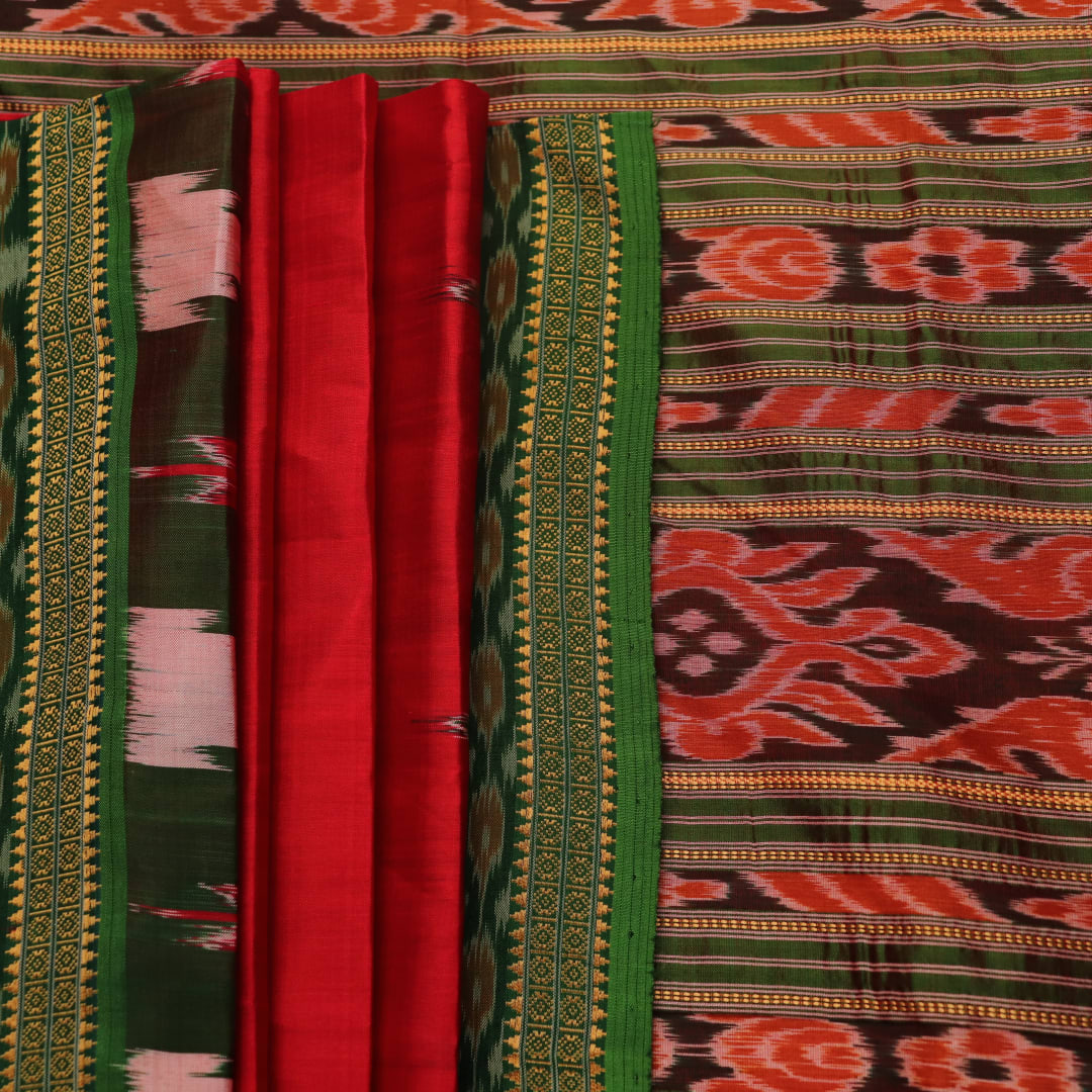 Red and green Khandua silk saree draped, showcasing the overall look and fall.