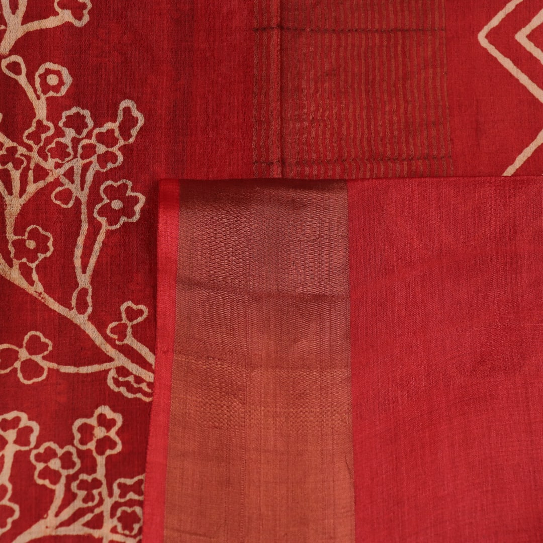 Close-up of the subtle slub and print on a handloom grey and rust Tussar silk saree fabric.