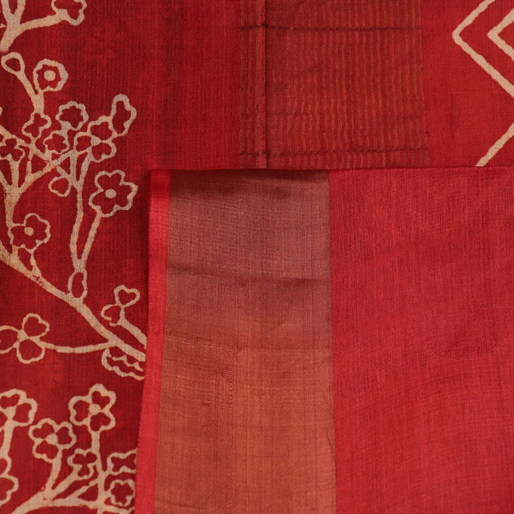 Close-up of the subtle slub and print on a handloom grey and rust Tussar silk saree fabric.