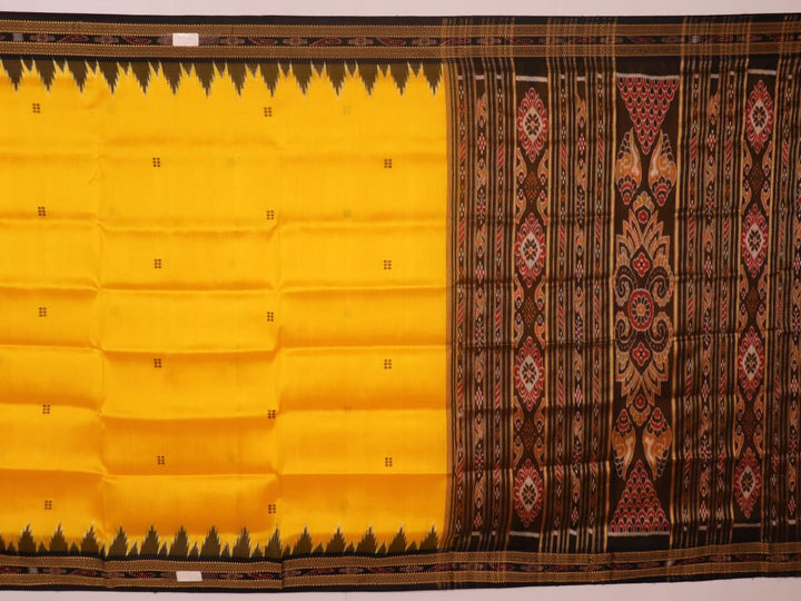 Model showcasing yellow Khandua silk saree with black butta pattern.