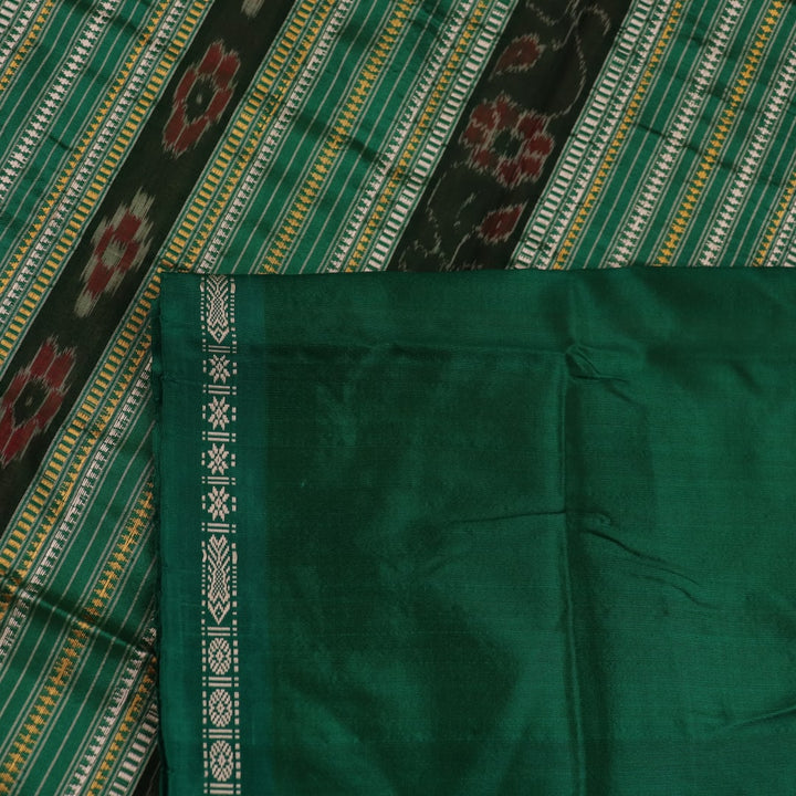 Close-up of the plain woven silk texture of a pink and green Sambalpuri saree.