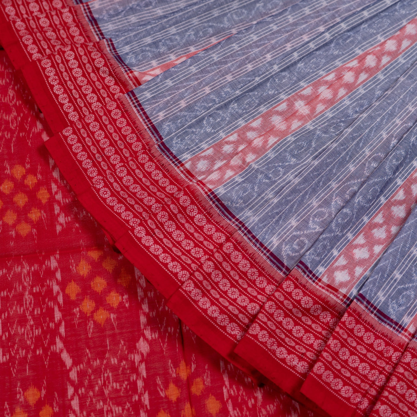 Folded presentation of the Grey and Red Sambalpuri cotton saree.
