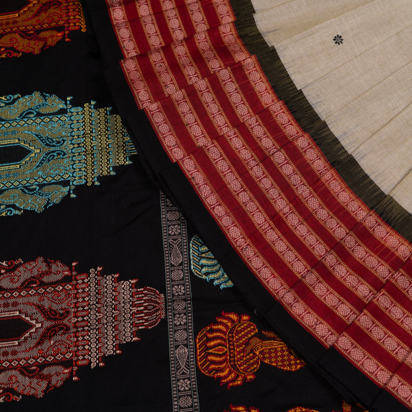 Folded presentation of the Grey and Black Bomkai cotton saree.