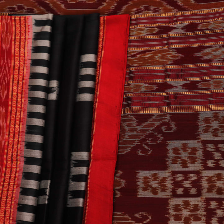 Khandua silk saree in black with red motifs, draped in a traditional style