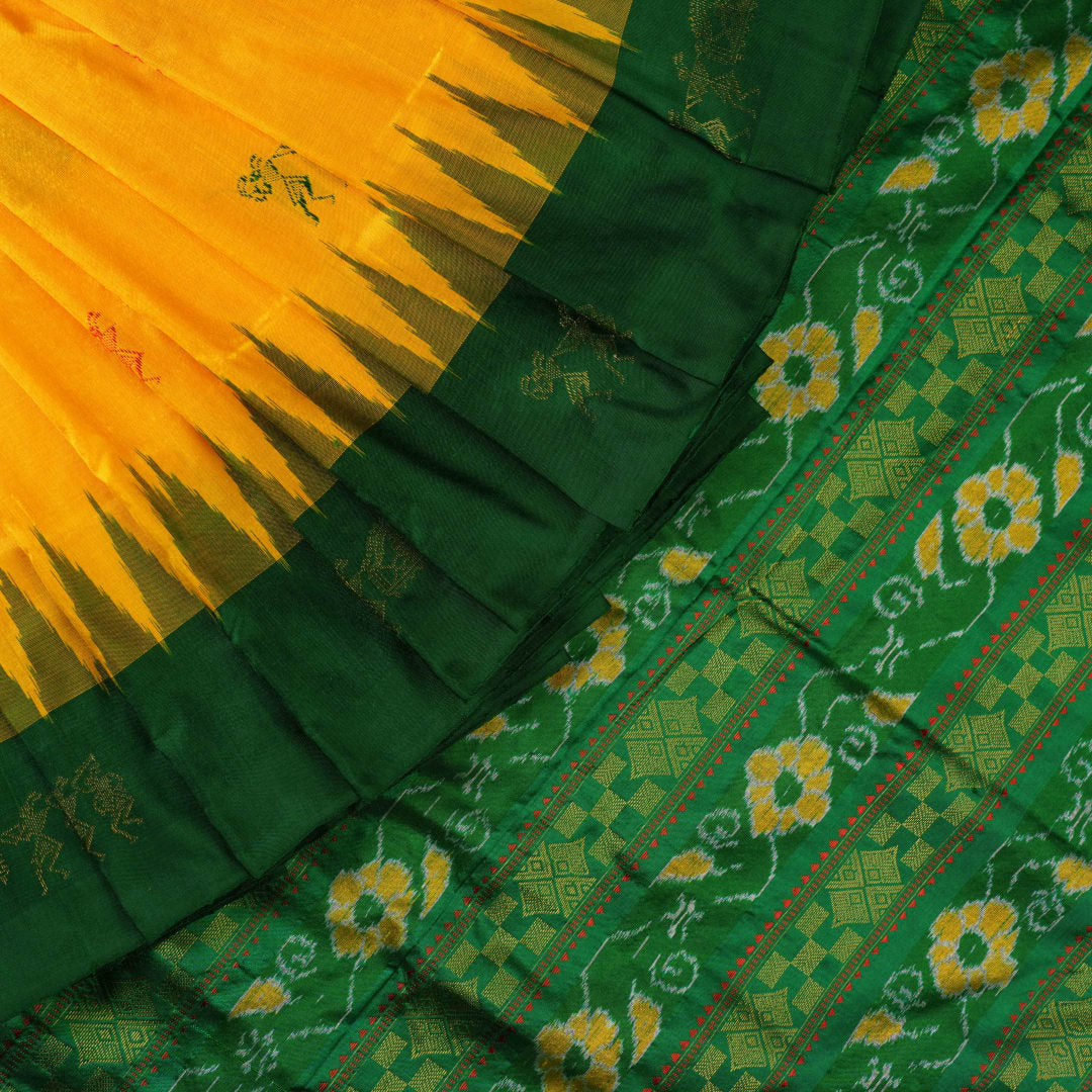 Extreme close-up of yellow Bomkai Silk Saree fabric, revealing the rich silk texture and weave.