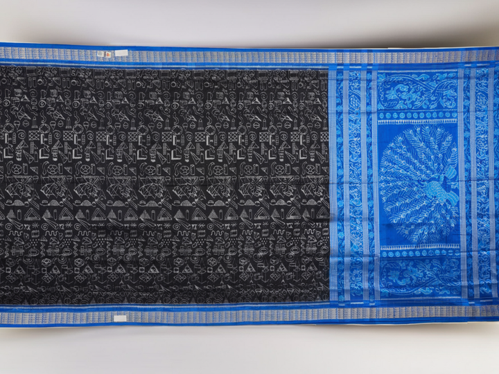 Close-up of Sambalpuri Silk saree fabric, revealing its rich texture and intricate black and blue weave.