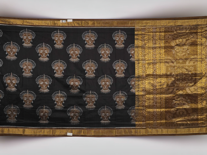 Close-up revealing the delicate, lustrous texture of the black silk tissue saree fabric with subtle sheen.