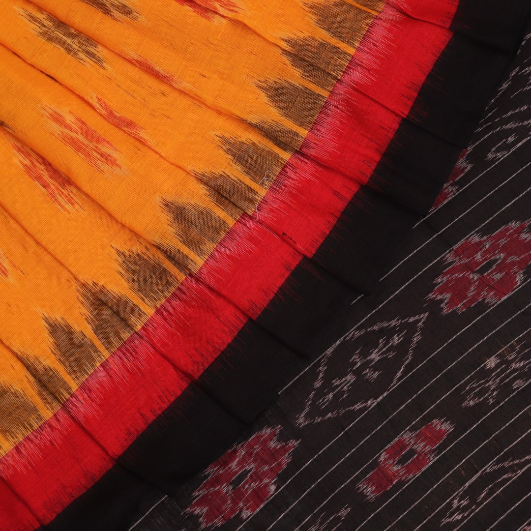 Styling shot showcasing a draped yellow and black Sambalpuri cotton saree with motif details.