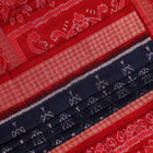 Close-up view of the blue silk Sambalpuri saree's fabric texture showcasing intricate motifs in red