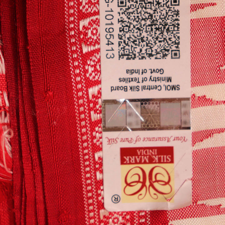 Close-up of plain white silk fabric with intricate Berhampuri weaving in red