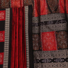 Detailed texture of handwoven Bomkai silk saree fabric in maroon and black with butta pattern.
