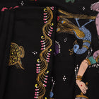 Close-up of black silk Patachitra saree fabric, showcasing hand-painted texture and detail.