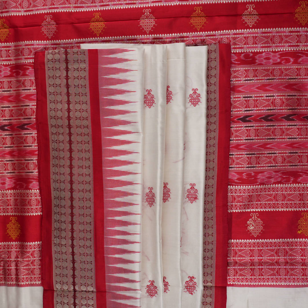 Extreme close-up revealing the rich Bomkai silk fabric texture and intricate handloom weave details in white and red.