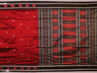 Detailed texture of handwoven Bomkai silk saree fabric in maroon and black with butta pattern.