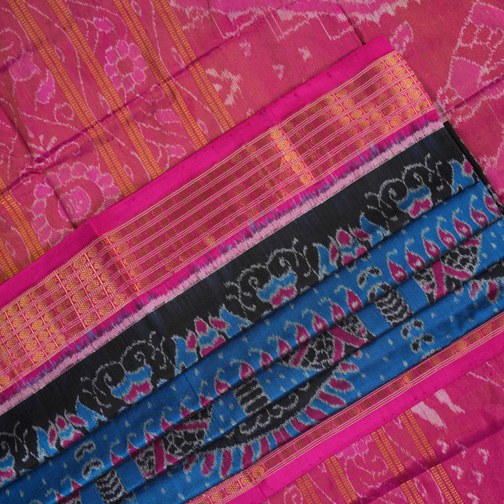 Close-up revealing the sheer tissue silk texture of the black saree, with subtle shimmering pink motifs.