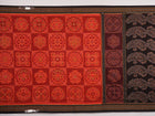 Full flat layout of the orange and black Sambalpuri cotton saree showing the body, border, and pallu