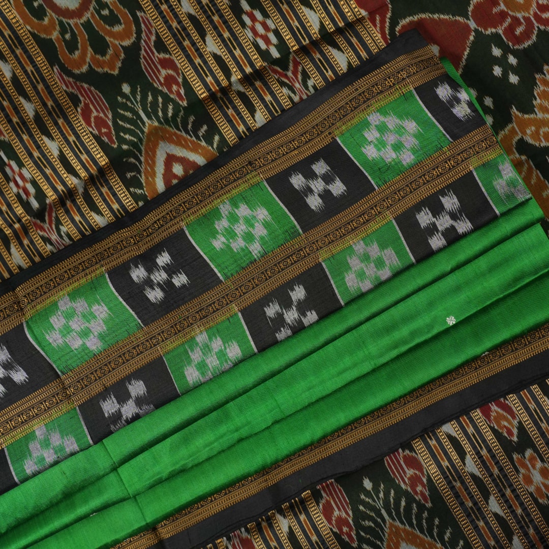 Model draped in a green and black Khandua silk saree with butta work, showcasing elegant ethnic styling.