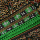 Model draped in a green and black Khandua silk saree with butta work, showcasing elegant ethnic styling.