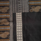 Extreme close-up of red Bomkai silk saree fabric showcasing rich texture and intricate weave.