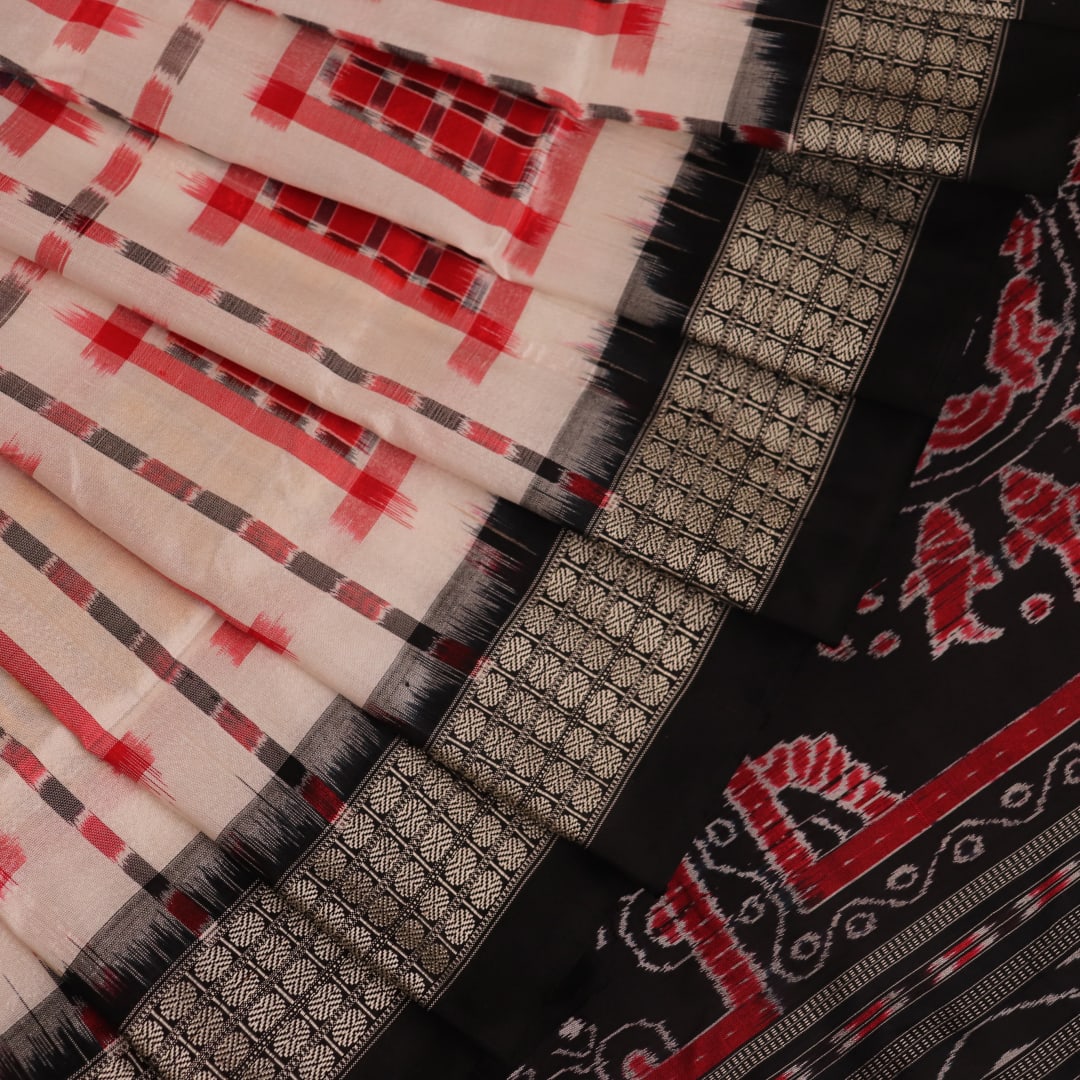 Close-up of white silk handloom saree with black Sambalpuri motifs