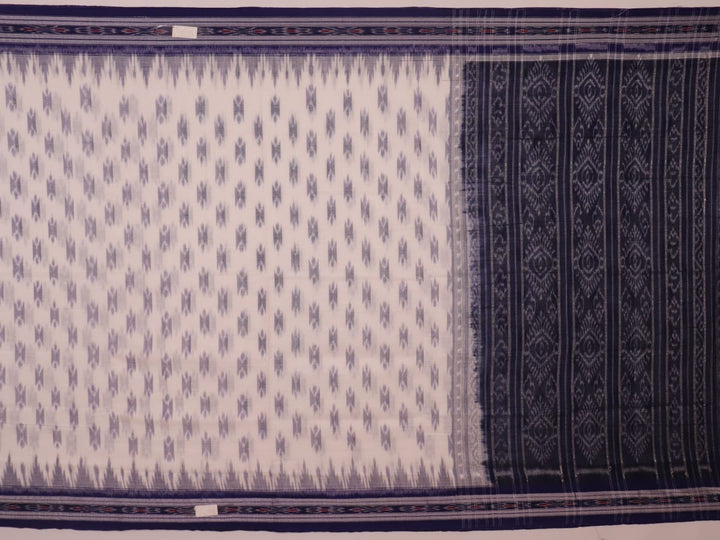 Model wearing a white Sambalpuri cotton saree with blue motifs, showcasing the drape and overall look.