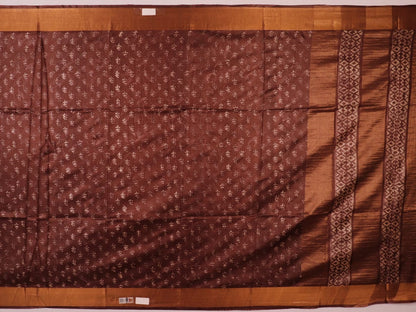 Close-up of the brown Tussar silk saree fabric, highlighting its natural slub texture and printed pattern.