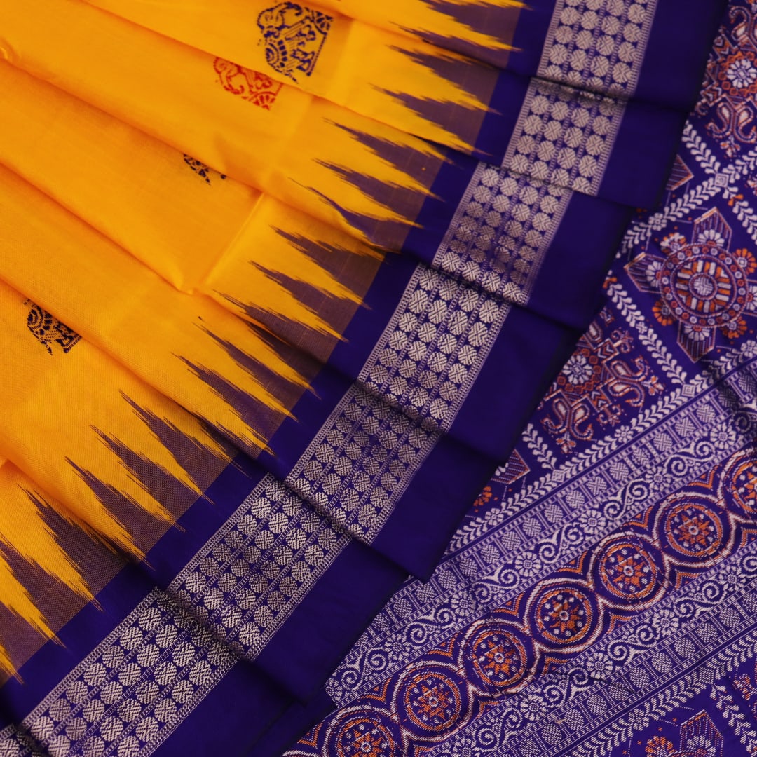 Close-up showcasing the yellow and blue butta pattern on the silk Bomkai saree fabric.