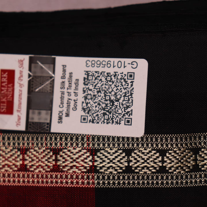 Close-up of maroon silk fabric with delicate butta patterns in black.