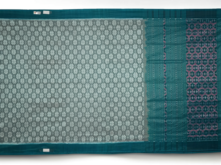 Close-up revealing the luxurious silk texture and subtle motif weave of the blue Sambalpuri saree.