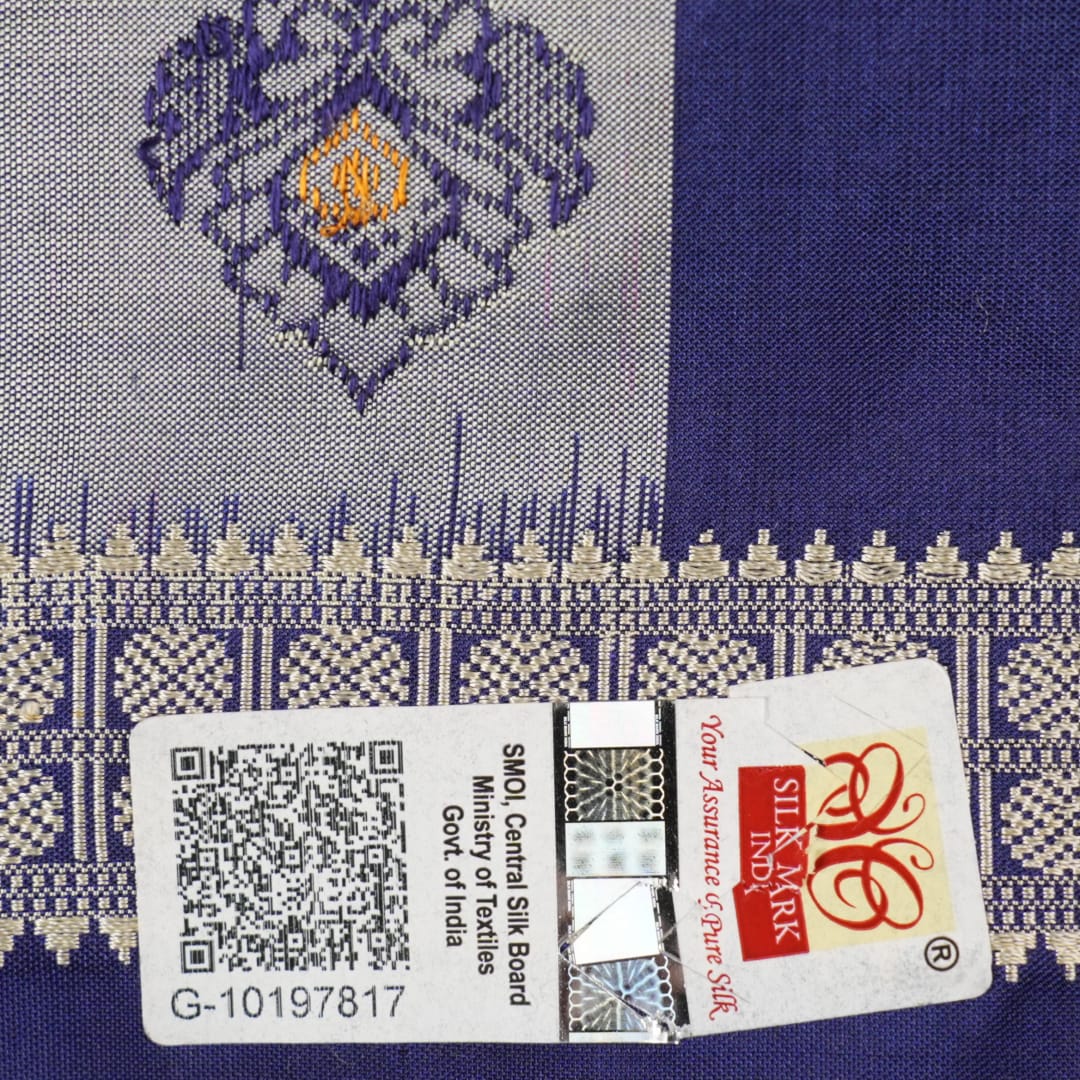 Close-up of luxurious Bomkai Silk Saree fabric texture, highlighting grey and blue handloom weave.