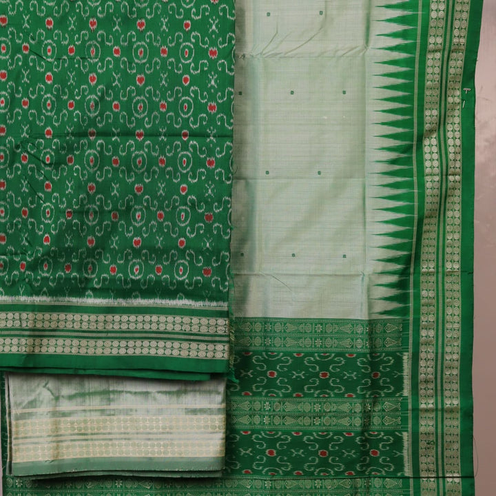 Close-up of the green Sambalpuri silk dress material blouse piece, detailed with traditional motifs.