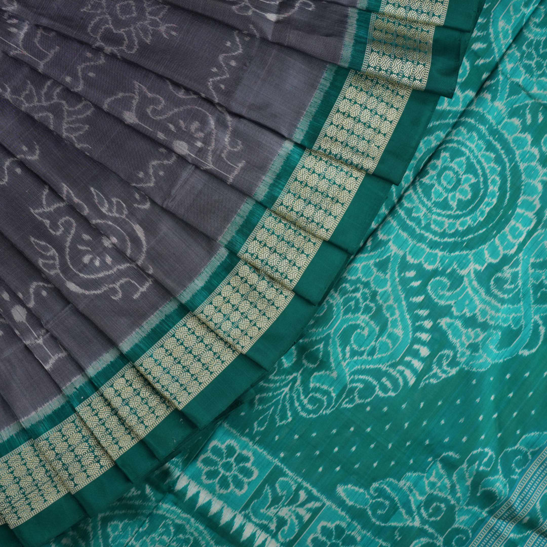 Extreme close-up of grey Sambalpuri silk fabric, revealing its fine handloom texture and weave quality.