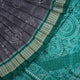 Extreme close-up of grey Sambalpuri silk fabric, revealing its fine handloom texture and weave quality.