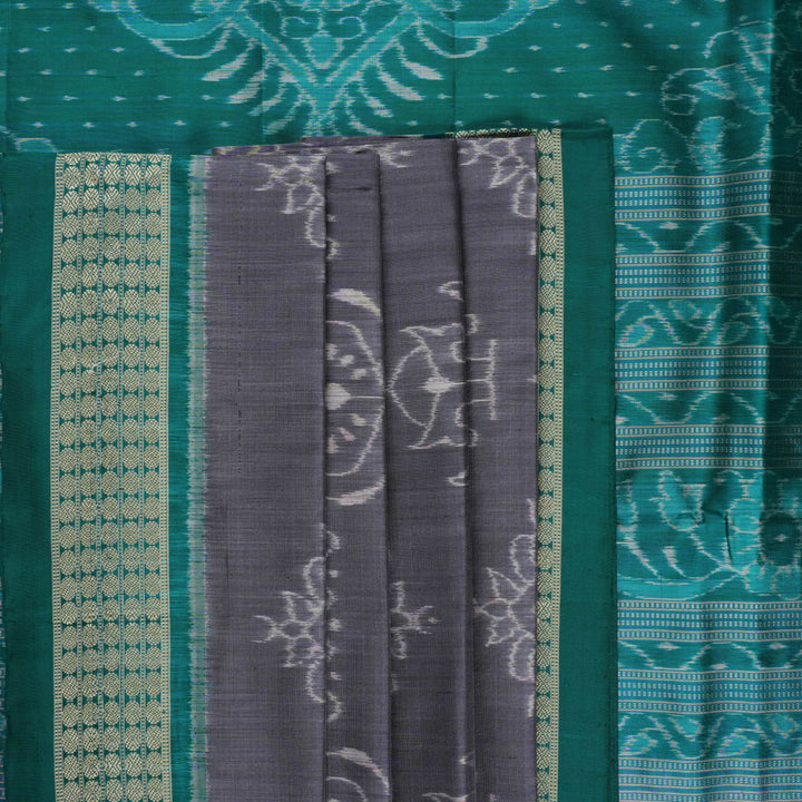 Extreme close-up of grey Sambalpuri silk fabric, revealing its fine handloom texture and weave quality.