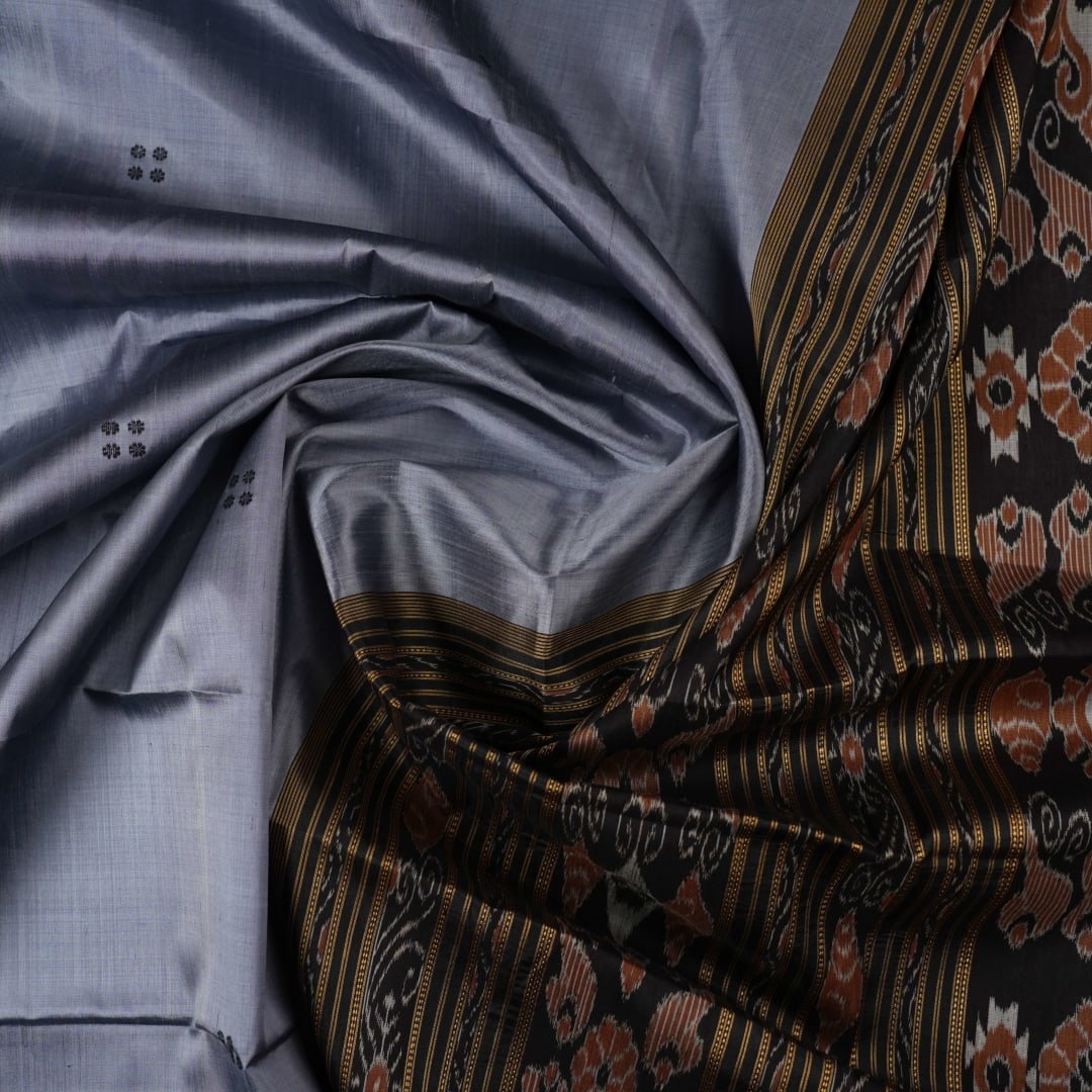 Full styling view of a model wearing a grey and black Khandua silk saree featuring elegant butta motifs.