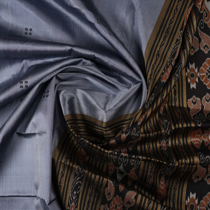Full styling view of a model wearing a grey and black Khandua silk saree featuring elegant butta motifs.