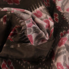 Off-white Sambalpuri cotton saree with green motifs, elegantly draped.