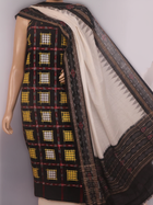 Detail of the black and white Sambalpuri cotton dress material's blouse piece with motifs.