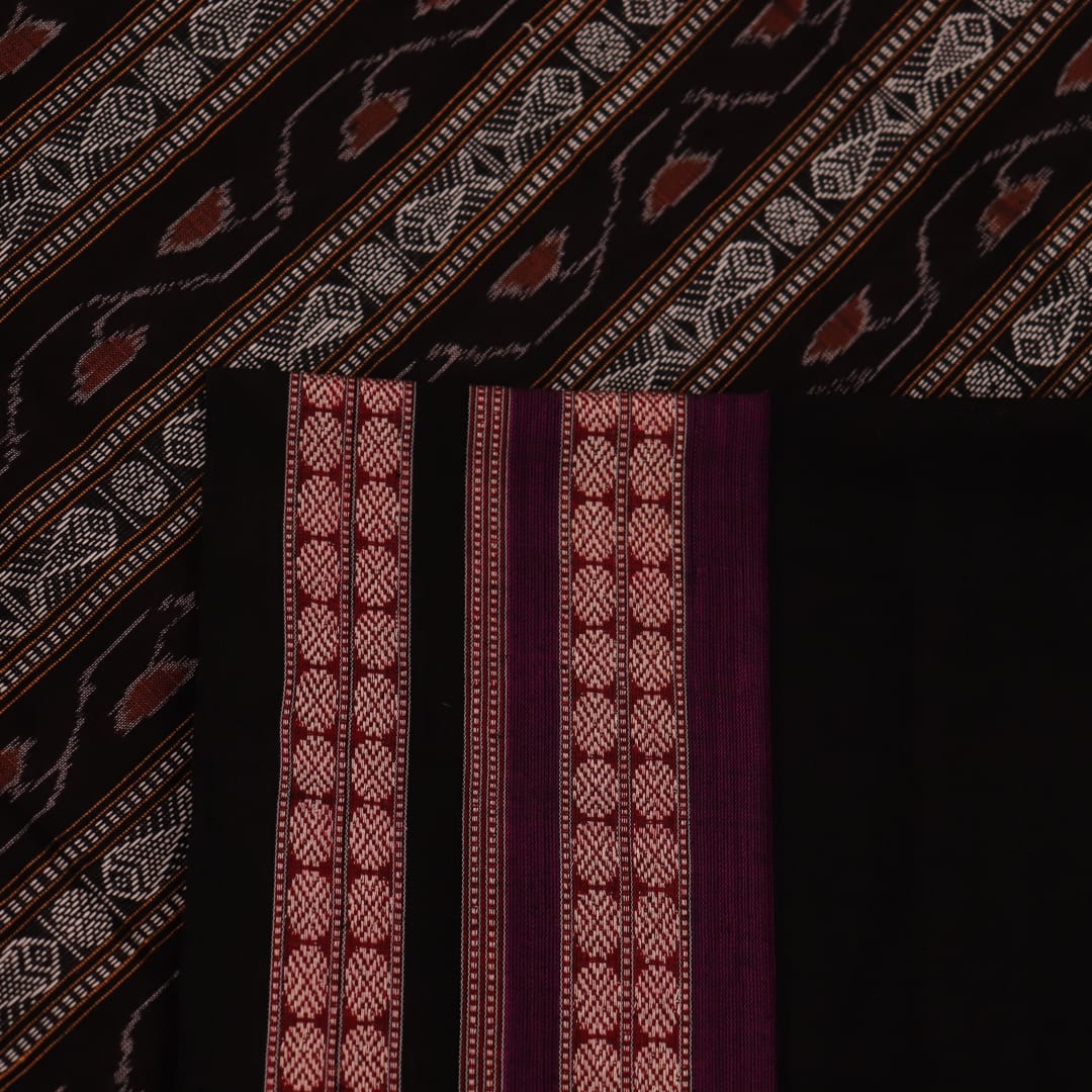 Full view of a magenta and black Bomkai cotton saree with intricate butta patterns.