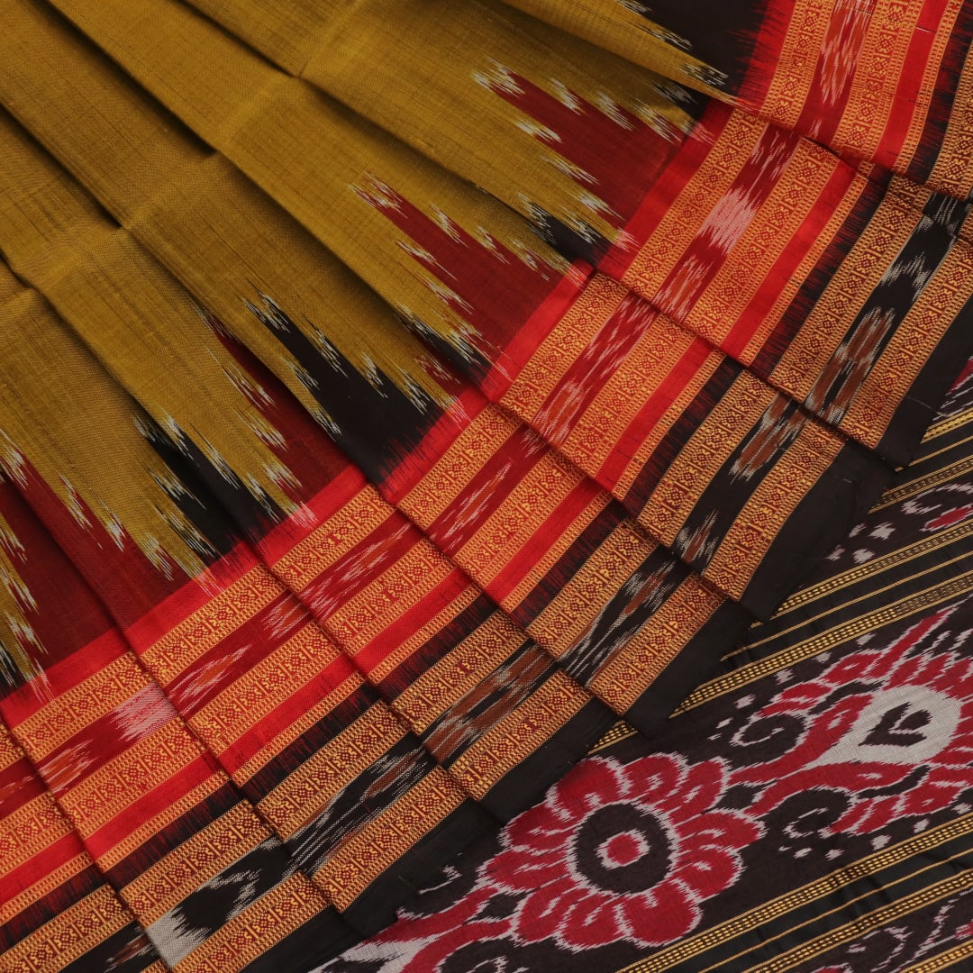 Green and black Khandua silk saree draped; showcasing its butta pattern and elegant fall.