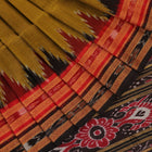 Green and black Khandua silk saree draped; showcasing its butta pattern and elegant fall.
