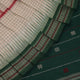 Full view of a white cotton Sambalpuri saree with green butta patterns.