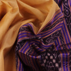 Woman draped in a cream and blue Khandua silk saree with butta pattern, showcasing the elegant drape and styling.