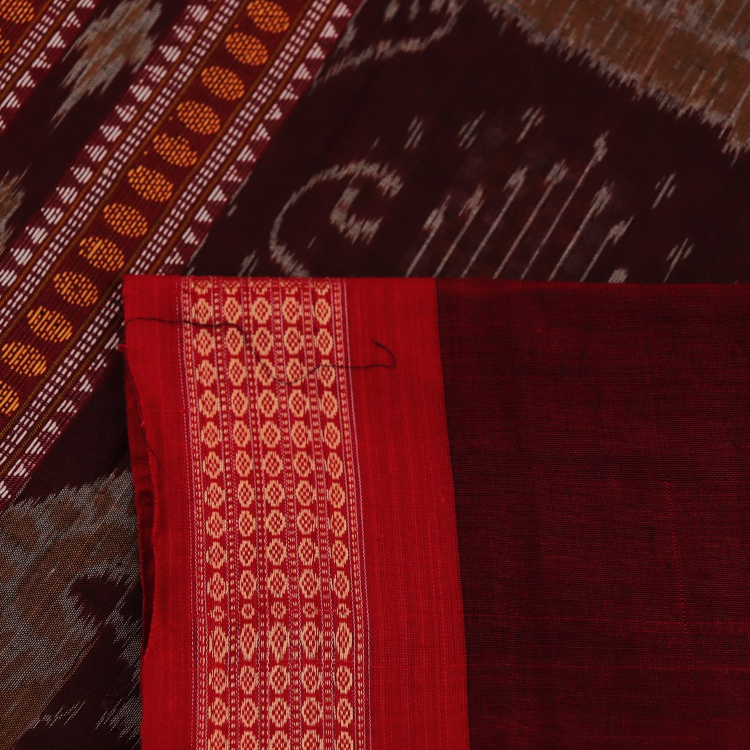 Full view of a green and red Bomkai cotton handloom saree with a butta pattern.