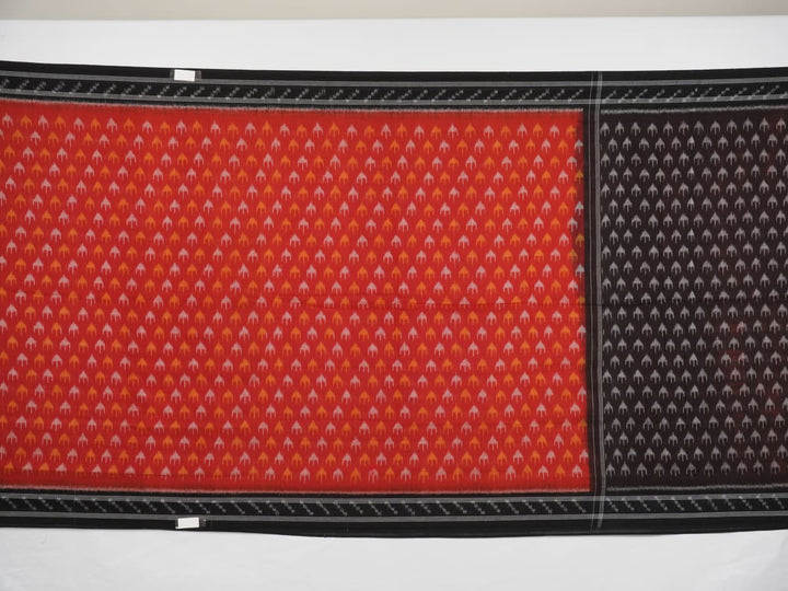 Model wearing a rust and black Sambalpuri cotton saree styled with traditional Odisha handloom motifs.