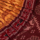 Yellow and maroon Sambalpuri cotton saree with motifs, draped elegantly to showcase its design.