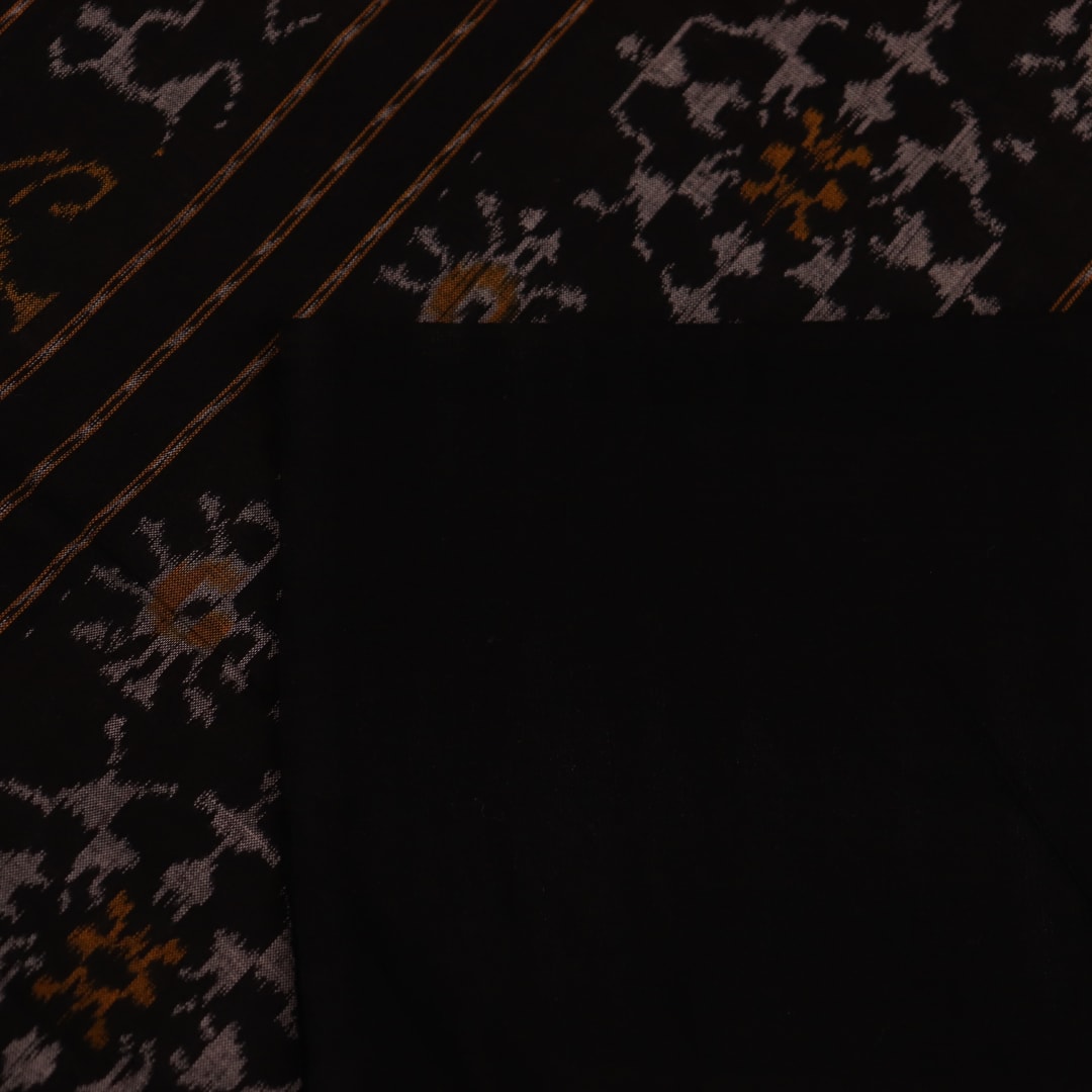 Full view of a peach-colored Sambalpuri cotton saree with black motifs.