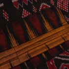 Brown and black plain Sambalpuri cotton saree styled, showcasing its elegant drape and subtle colors.