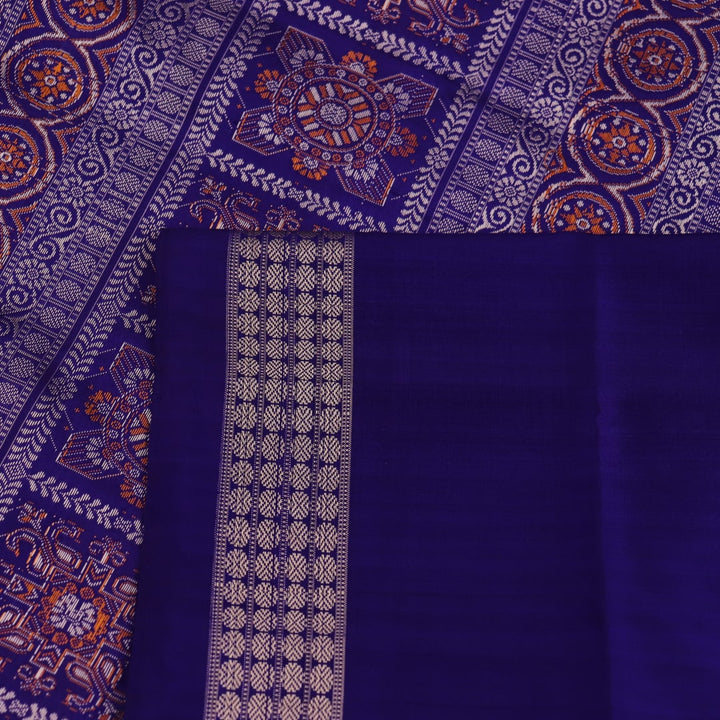 Close-up showcasing the yellow and blue butta pattern on the silk Bomkai saree fabric.