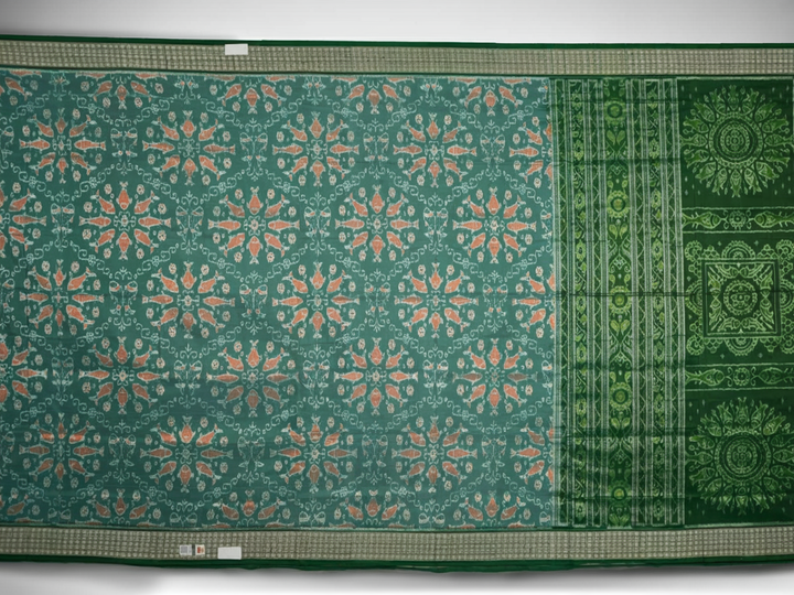 Ultra close-up of green Sambalpuri silk saree fabric, highlighting its luxurious texture and weave.